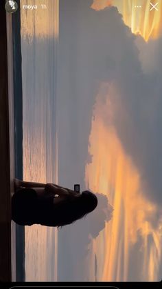 an image of a person looking out the window at something in the sky that is yellow and orange