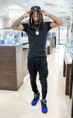 a man with dreadlocks standing in a store