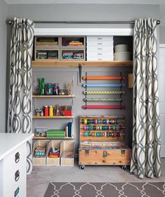 an organized craft room with lots of storage