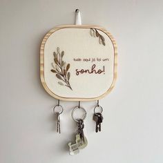 a wall hanging with some keys attached to it