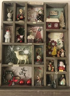 a wooden shelf filled with christmas decorations and figurines