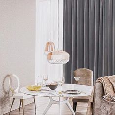 a dining room table and chairs in front of a window