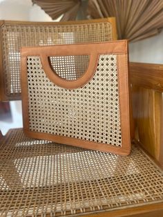 a brown purse sitting on top of a wooden chair