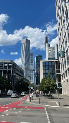 a city street with tall buildings in the background