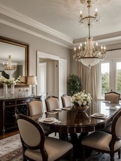 a formal dining room with chandelier and large table in front of the window