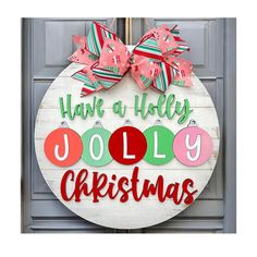 a christmas door hanger with the words have a holly jolly christmas on it's front