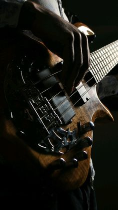 a person playing an electric guitar in the dark