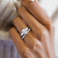 a woman's hand with a diamond ring on it