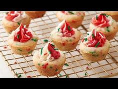 christmas cupcakes with frosting and sprinkles on a cooling rack