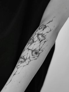 a woman's arm with an eye tattoo on it