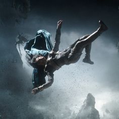 a man falling in the air while holding onto another person's leg and head