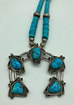 Incredibly stunning Native American handmade Naja necklace is made of sterling silver with natural turquoise stones and turquoise beads. The chain of the necklace has 48 sterling silver beads and 70 turquoise stone beads. The Naja is large and is made of sterling silver, with 5 large natural turquoise stones on it.  Condition: Excellent!  Artist: Unknown/Unsigned  Weight: 92 grams  Measurements: 21 inches long *48 Silver Beads: 7mm x 5mm (2 small beads) 8mm x 7mm (42 medium beads) 13mm x 10mm (4 Hand-strung Turquoise Sterling Silver Jewelry, Traditional Turquoise Sterling Silver Necklace, Artisan Sterling Silver Turquoise Beaded Necklace, Unique Silver Hand-strung Turquoise Necklace, Unique Silver Turquoise Hand-strung Necklace, Unique Silver Turquoise Necklace Hand-strung, Southwestern Turquoise Necklaces With Silver Beads, Hand-strung Turquoise Necklace With Sterling Silver Round Beads, Sterling Silver Turquoise Necklace With Polished Beads