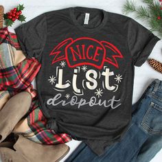 a t - shirt that says nice list dropout on it next to jeans and christmas decorations