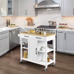 a kitchen with white cabinets and an island in the middle, surrounded by stainless steel appliances