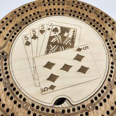 an image of playing cards on a wooden plaque