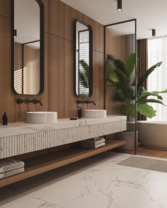 a bathroom with two sinks and mirrors on the wall next to a plant in a vase