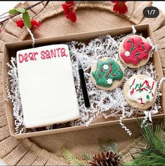 decorated cookies in a box with writing on them