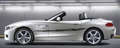 the bmw z4 roadster convertible is parked in a garage