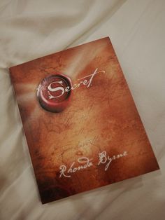 a book on a bed with the title scott and rose written in white ink next to it