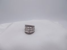 This is a vintage sterling silver ring. Wide in front this ring has a raised sterling & scroll design. This ring is a size 5 & 1/4. Vintage Sterling Silver 925 Wide Band Ring, Vintage Silver Wide Band Ring, Vintage Silver Wide Band Ring Stamped 925, Silver Stackable Wide Band Rings Stamped 925, Vintage Silver Engraved Wide Band Ring, Vintage Wide Band Open Ring Stamped 925, Antique Silver Ring With Decorative Band, Silver Engraved Ring With Decorative Wide Band, Antique Silver Rings With Decorative Band