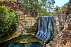 a large waterfall with water coming out of it