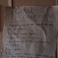 a piece of paper with writing on it that says cabin construction written in cursive handwriting