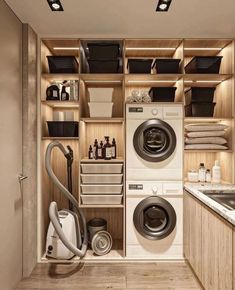 a washer and dryer in a small room with wooden shelves on the wall