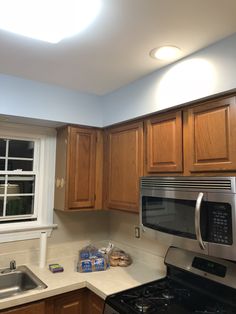 a kitchen with wooden cabinets and stainless steel appliances