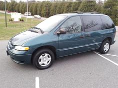 a green van parked in a parking lot