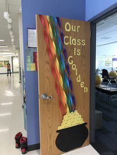 a door decorated with paper straws and a sign that says our class is golden