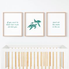 three framed prints on the wall above a crib in a baby's room