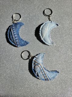 two denim key chains with holes in them