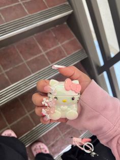 a person holding a hello kitty case in their hand