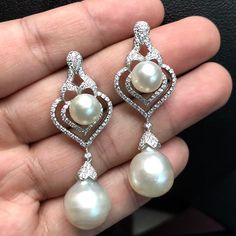 We are presenting you a HUGE pair of CHANDELIER, Genuine, PURE White South Sea Pearls, extremely FINE A+, LUSTROUS and Rare! Accenting the 4 pearls are 136 pieces of E/VS Natural diamonds, weighting a total of 1.62 carats. Set in fabulously designed 18K solid white gold earrings ONLY ONE ITEM AVAILABLE!! NO DUPLICATES!! WHAT YOU SEE IN THE PICTURES IS WHAT YOU WILL GET SOLIDLY HANDCRAFTED EARRINGS! SUGGESTED RETAIL VALUE: $10,880 PEARLS: Size: Bottom Pair 14 x 15 mm, Top Pair 11 mm. Shape: Round Luxury Drop Pearl Earrings, Luxury Teardrop Earrings With High Luster, White Diamond Teardrop Chandelier Earrings, Classic White Drop Chandelier Earrings, Luxury White Gold Teardrop Pearl Earrings, Elegant White Jewelry With High Luster, Luxury Pierced Dangle Bridal Earrings, Elegant White Drop Chandelier Earrings, Luxury White Gold Drop Pearl Earrings