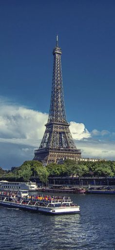 the eiffel tower towering over the city of paris from across the river seine