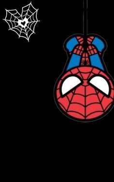 a spiderman face hanging from a wire on a black background with the word, happy halloween