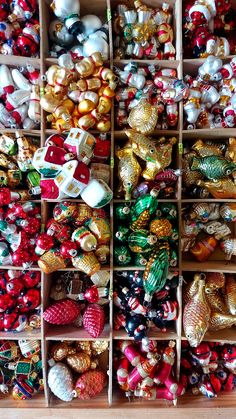 a collection of christmas ornaments in wooden boxes