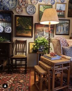 a living room filled with furniture and plates on the wall