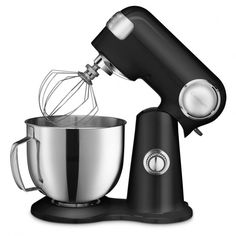 an electric mixer with a metal bowl on the side and a whisk attachment