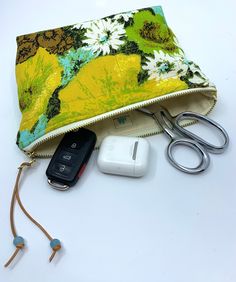 "Made with vintage repurposed 1970s cotton fabric. This is a gorgeous and unique zipper pouch, measuring approximately 8\" wide and 6\" high with a flat boxed bottom for standing on its own. It can hold all the things you need to bring into the market - cards, phone, glasses, lip balm- leave your big purse in the car! Made with a groovy and cheerful vintage yellow and turquoise flower fabric. Lined with premium linen. Strong metal zipper with a leather pull and stone beads. This bag is very stur Yellow Zipper Pouch For Personal Use, Yellow Zipper Pouch Cosmetic Bag For Everyday Use, Handmade Green Pouch For Travel, Yellow Pouch Cosmetic Bag For Everyday Use, Yellow Everyday Pouch Cosmetic Bag, Handmade Green Travel Pouch, Yellow Rectangular Cosmetic Bag With Zipper, Handmade Green Pouch, Yellow Cosmetic Pouch For Everyday Use