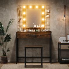 a vanity with lights on it and a mirror over the top that is lit up