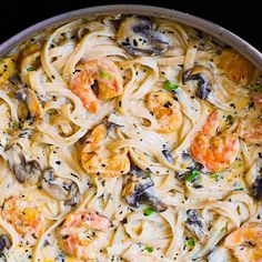 pasta with shrimp, mushrooms and cheese in a skillet