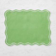 a green place mat on a white surface with an empty space in the middle for writing