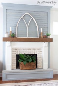 a fireplace with a white mantle and blue walls