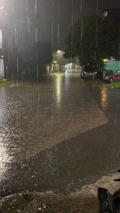 the street is flooded with water at night