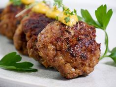 two meat patties with mustard and parsley on top