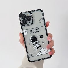 a woman holding up a phone case with an astronaut on it