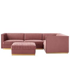 a pink velvet sectional sofa with gold legs and footstools on an isolated white background