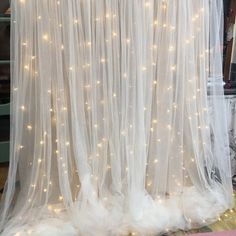 a white curtain with lights hanging from it