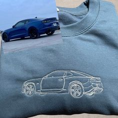 a blue sports car embroidered on the back of a t - shirt next to a photo of it